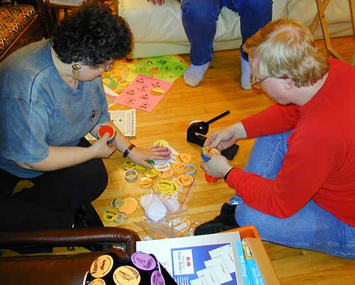Sharon and Kevin prepare volunteer buttons 