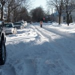 Both cars and pedestrians move in the tire tracks.
