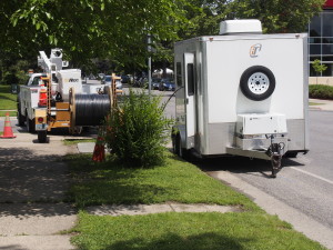 Spool of cable, and splicing trailer in action at Blaisdell and 34th St.