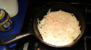 Flatten potato shreds in pan