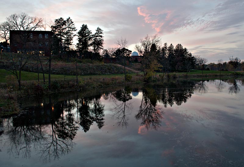 Language and Dining Center and Goodsell Observatory across Lyman Lakes at dusk.