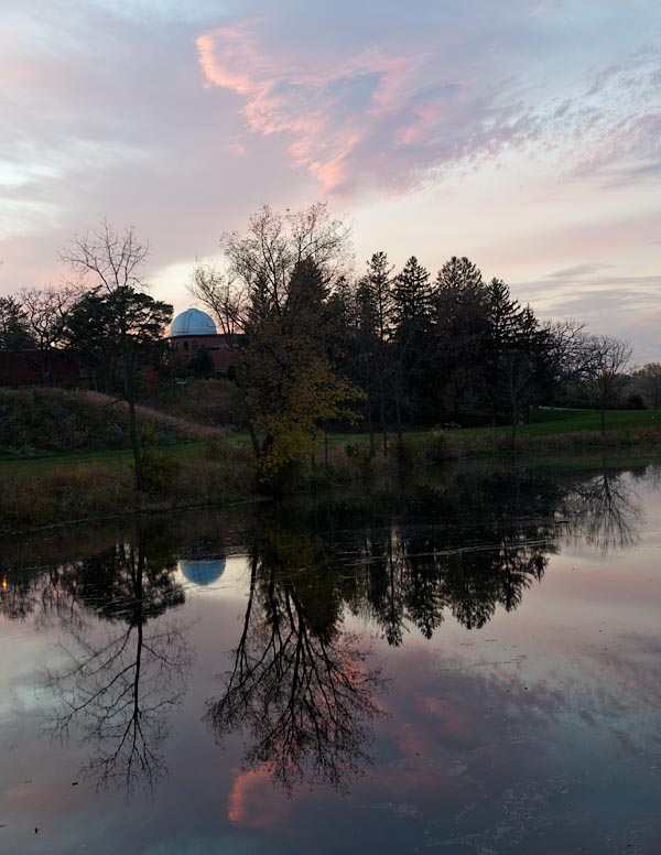 Goodsell Observatory across Lyman Lakes at dusk.