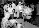 Robert A. Heinlein signing book for Beth Friedman, with many unidentified people waiting in line. 