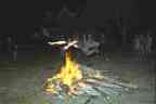 Corwin Brust leaps the bonfire